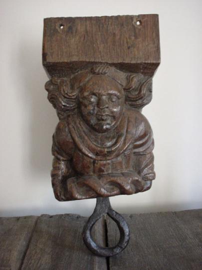 Humourous medieval oak font cover pulley of an angel lifting a crown of thorns
