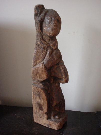 Northern French or English pre Conquest or early medieval oak staircase finial of a monk on a bench